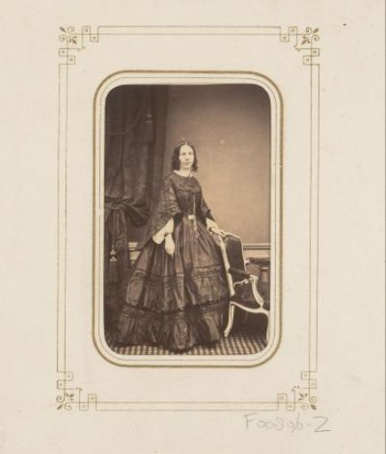 Portrait of a woman by a chair