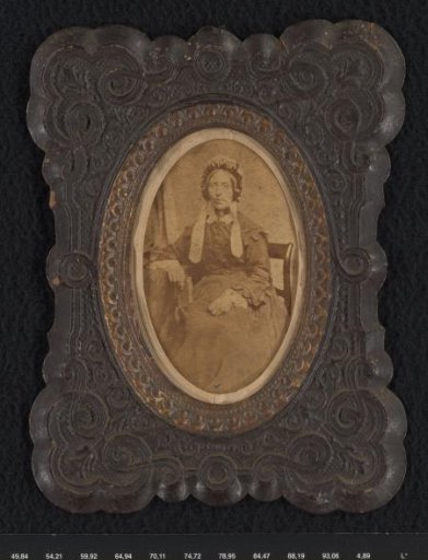 Portrait of a seated woman with a cap with ribbons