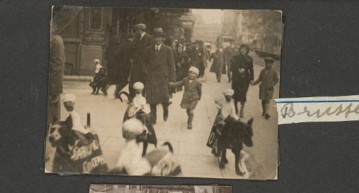The Puppet Doctor with a child by the hand and dogs with advertising signs and confectioner puppets on their backs