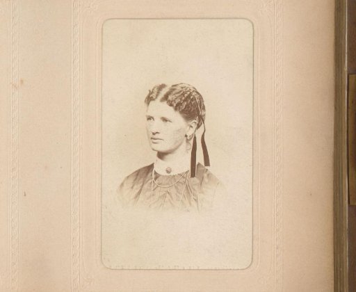 Portrait of a woman with a necklace and ribbons in her hair