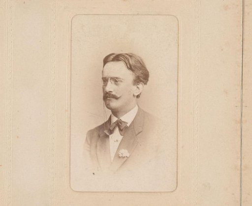 Portrait of a man with a mustache, spectacles, and a bow tie