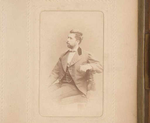 Portrait of a seated man with a mustache and beard