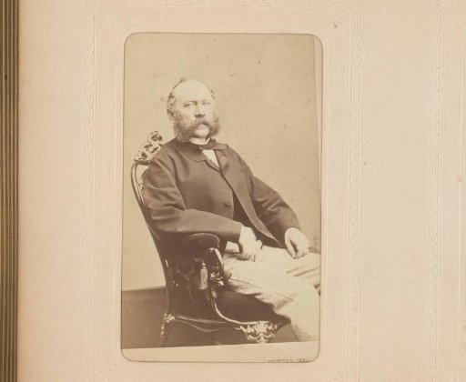 Portrait of a seated man with a mustache and sideburns