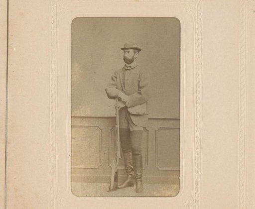 Portrait of a standing man with a hat and a bag with a hunting rifle in his hand