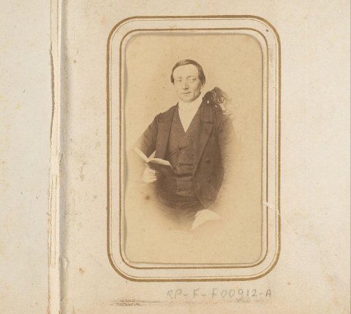 Portrait of a seated man with a book