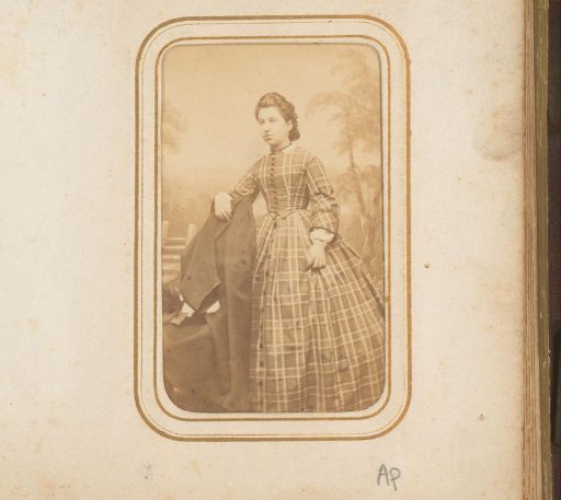Portrait of a woman standing by a chair