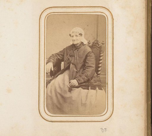 Portrait of an Elderly Seated Woman Wearing a Cap