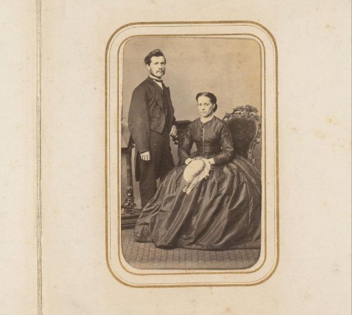 Portrait of a man and a seated woman with a hat