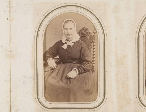 Portrait of a seated girl in a white linen cap