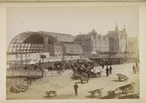 View of the Central Station from the southwest with men with hand carts in the foreground