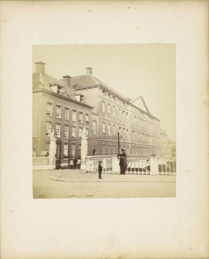 Building with access gate in Utrecht with a man and a child in the foreground
