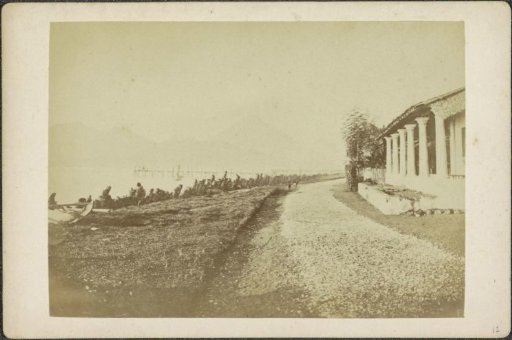 Shore with a house on the water in Tidore, with mountains in the background
