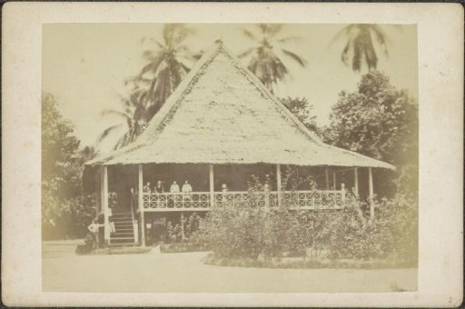 Group posing on the veranda of an estate in Ternate