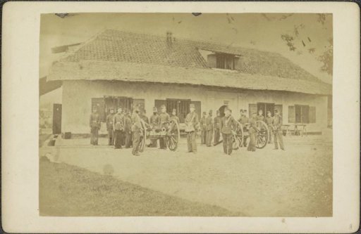 Soldiers posing with cannons in front of the artillery barracks on the ramparts of the fort in Ternate