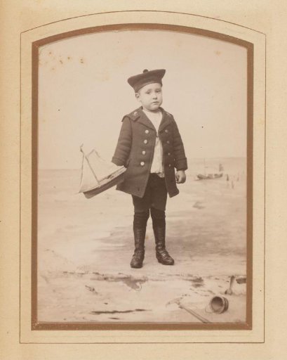 Portrait of a boy with a toy boat