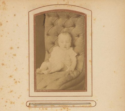 Portrait of a child, seated on a chair