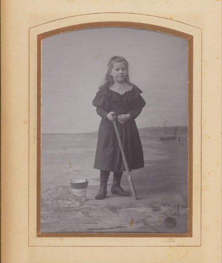 Portrait of a girl with a bucket and shovel