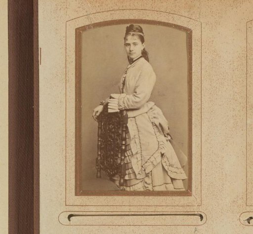 Portrait of a young woman, standing by a chair