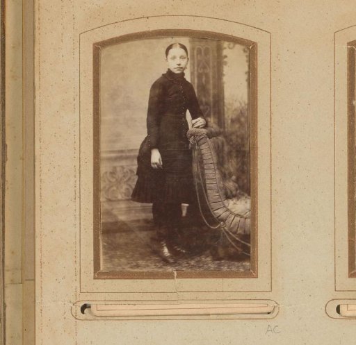 Portrait of a Girl Standing by an Armchair