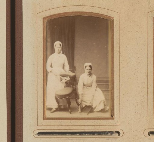 Portrait of a maid sweeping the floor and a maid shaking out a chair