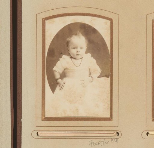 Portrait of a baby with a necklace and bracelets