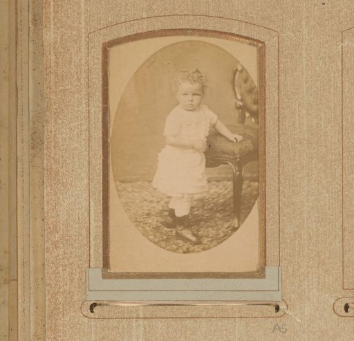 Portrait of a Toddler Standing by a Chair
