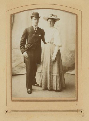 Portrait of a standing man and woman with hats