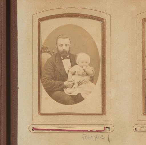 Portrait of a seated bearded man with a baby on his lap