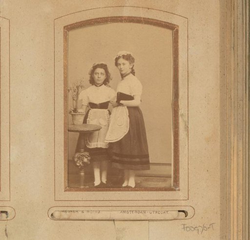 Portrait of two standing girls in traditional dress