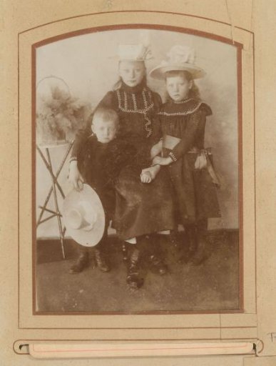 Portrait of two girls and a boy with hats