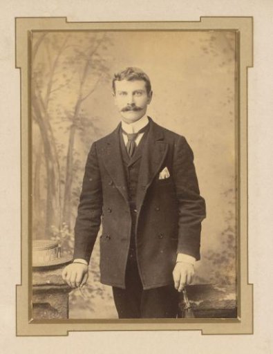 Portrait of a standing man with a moustache