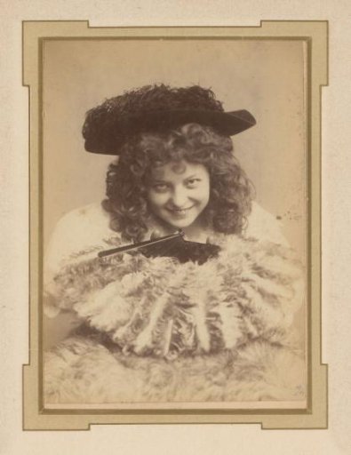 Portrait of a young woman with a hat and a fan