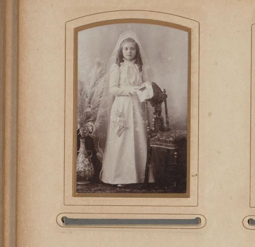 Portrait of a standing girl in a communion dress