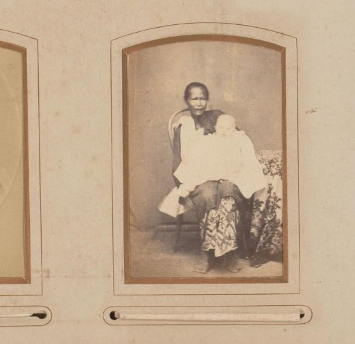 Portrait of a seated Indonesian woman with a European baby on her lap