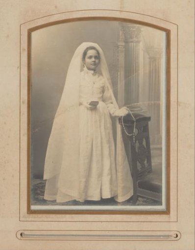 Portrait of a standing young woman in wedding attire
