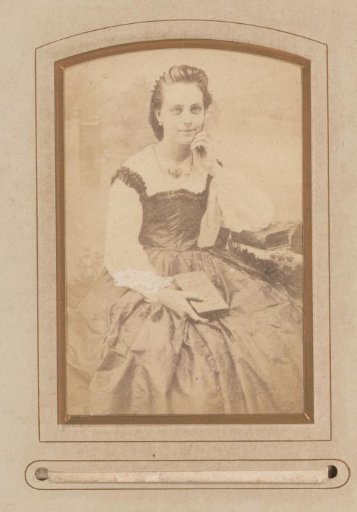 Portrait of a seated woman with a book in her hand