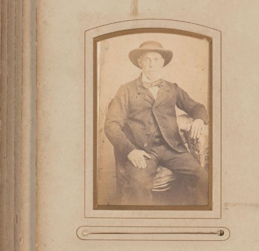 Portrait of a seated man with a hat