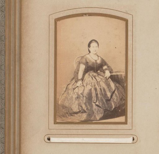 Portrait of a woman seated at a table