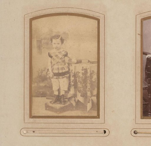 Portrait of a child, standing by a table with books