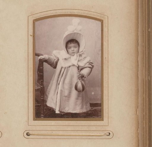 Portrait of a standing girl with a coat and hat
