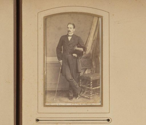 Portrait of a standing man with a walking stick and top hat