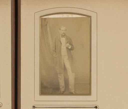 Portrait of a standing man in an overcoat