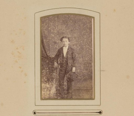 Portrait of a Standing Boy Holding a Hat