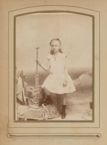 Portrait of a Standing Girl Holding a Shovel