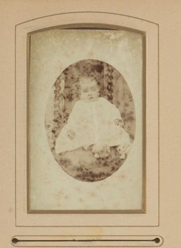 Portrait of a Seated Baby in a White Dress