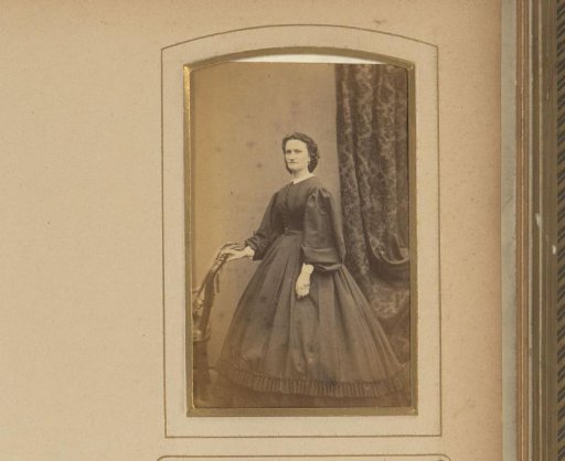 Portrait of a Woman Standing Beside a Chair