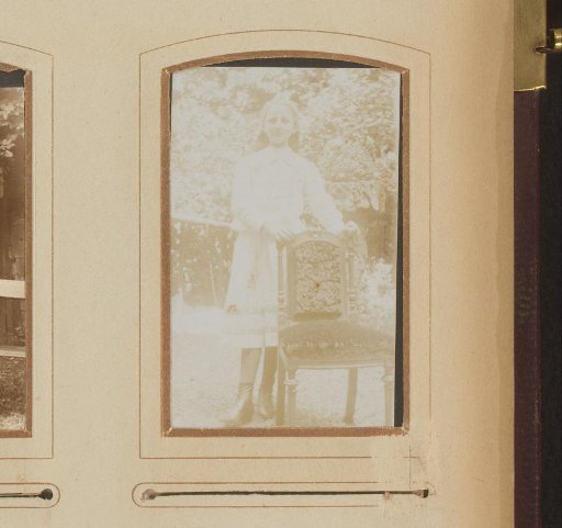 Portrait of a Girl Standing by a Chair in a Garden