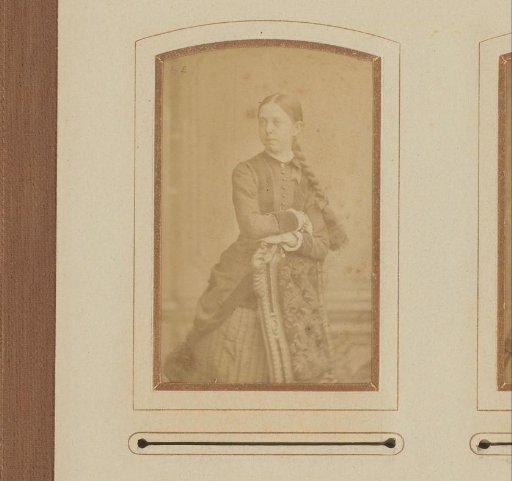 Portrait of a standing girl, leaning on the back of a chair
