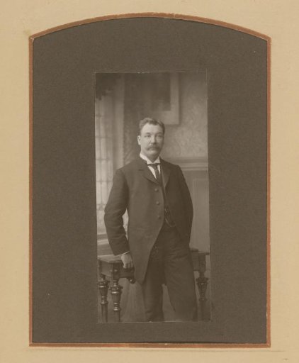 Portrait of a Man with a Mustache, Standing by a Table