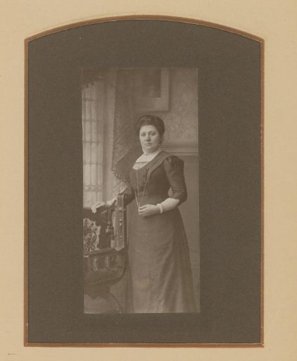 Portrait of a Woman with a Necklace, Standing by a Chair